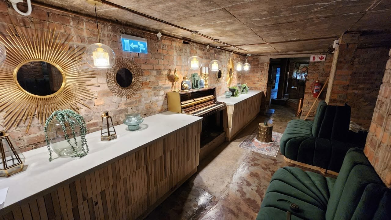 White stone bar counter tops in a restaurant venue with exposed brick walls